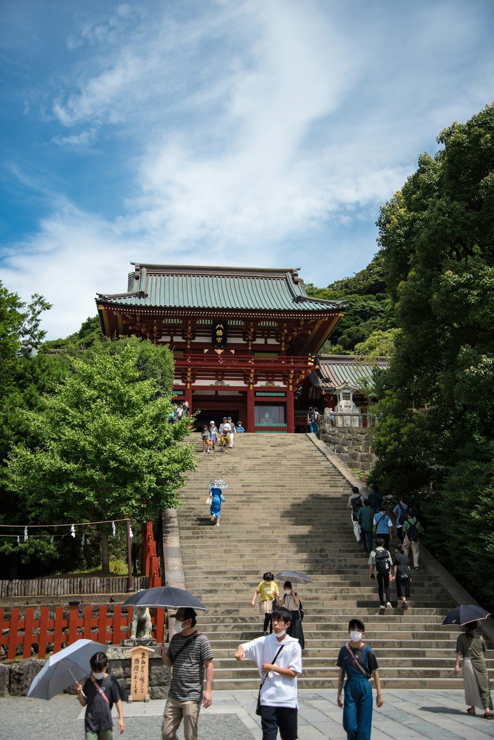 a group of people walking up stairs to a building