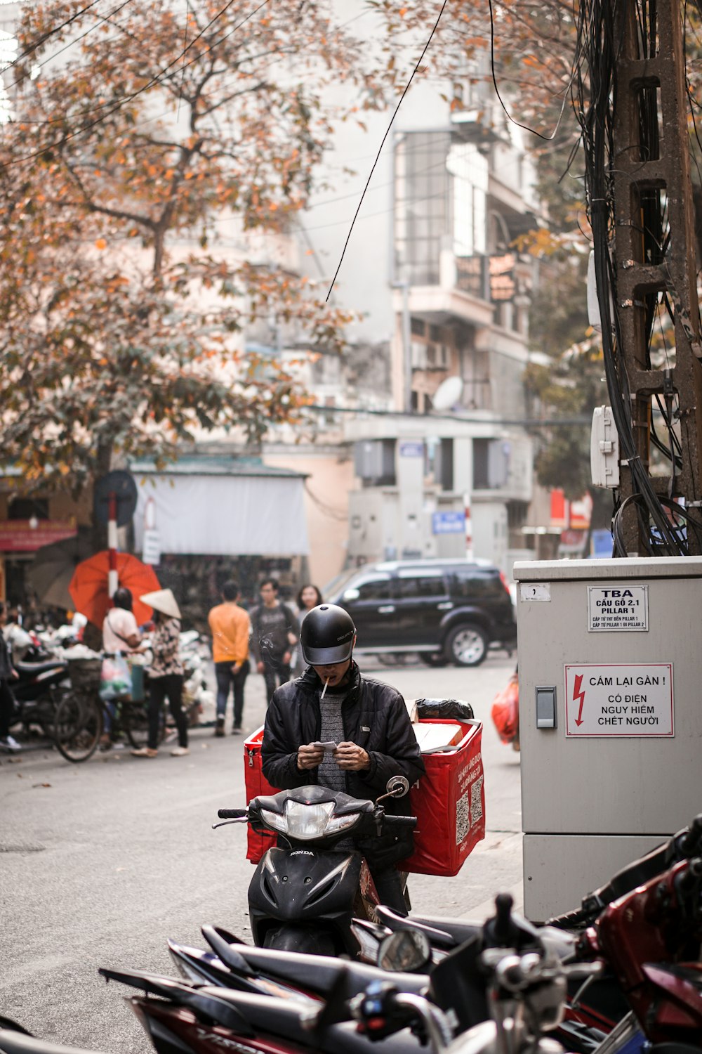 a person riding a scooter down a busy street