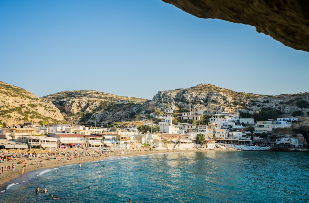 a beach with people and buildings