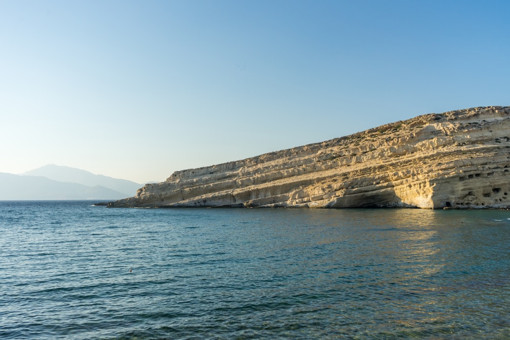 a cliff next to the water