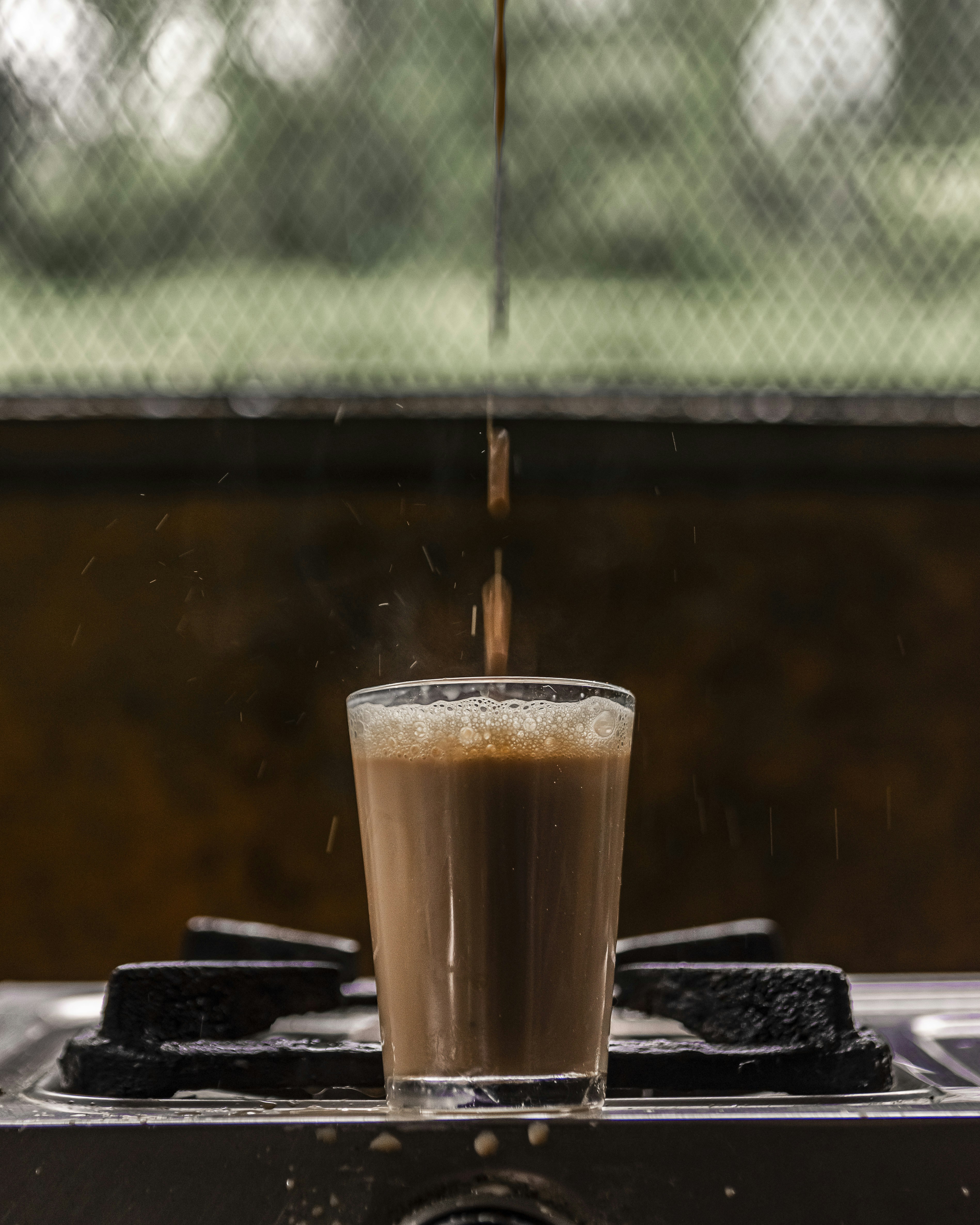 a glass of liquid on a table