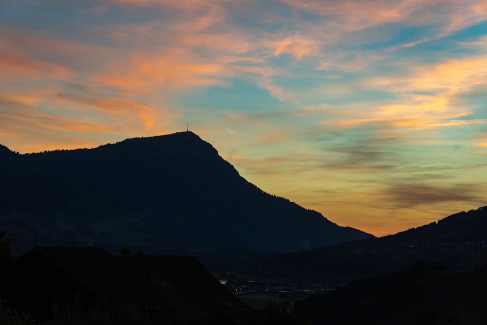 a mountain with a sunset in the background