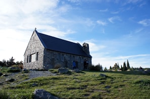 Glenbervie church standing proudly under a bright blue sky.