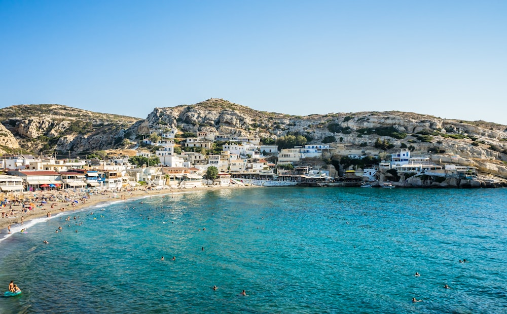 a beach with people swimming