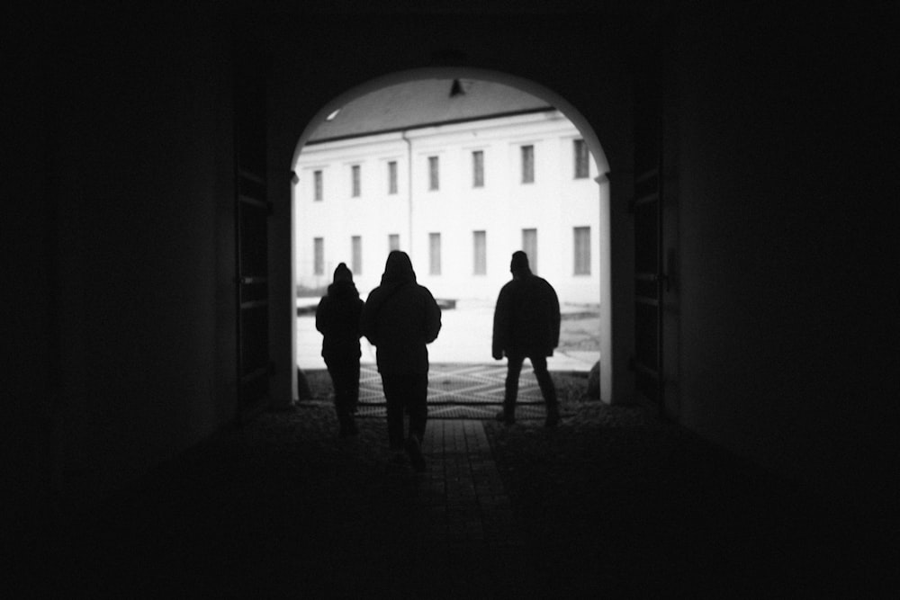 a group of people walking in a dark room