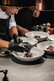 a person plating a restaurant meal