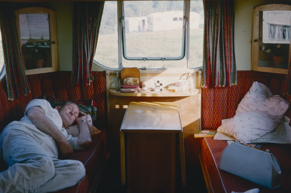 a person sitting on a bed in a room