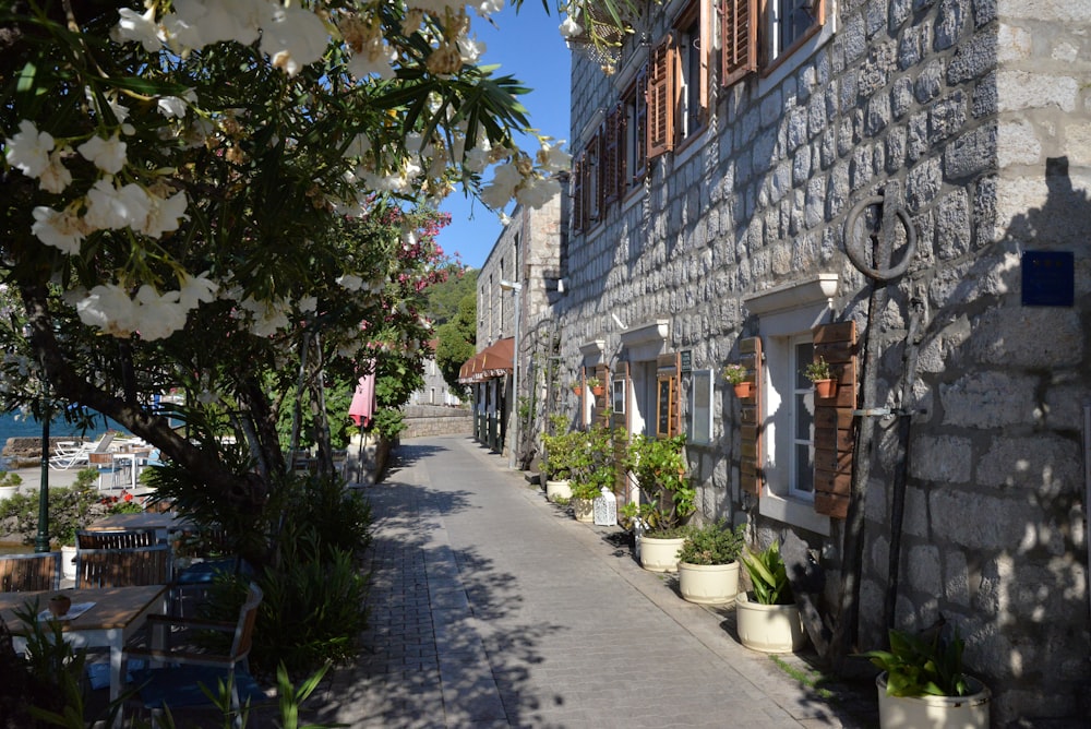 a narrow street with tables and chairs