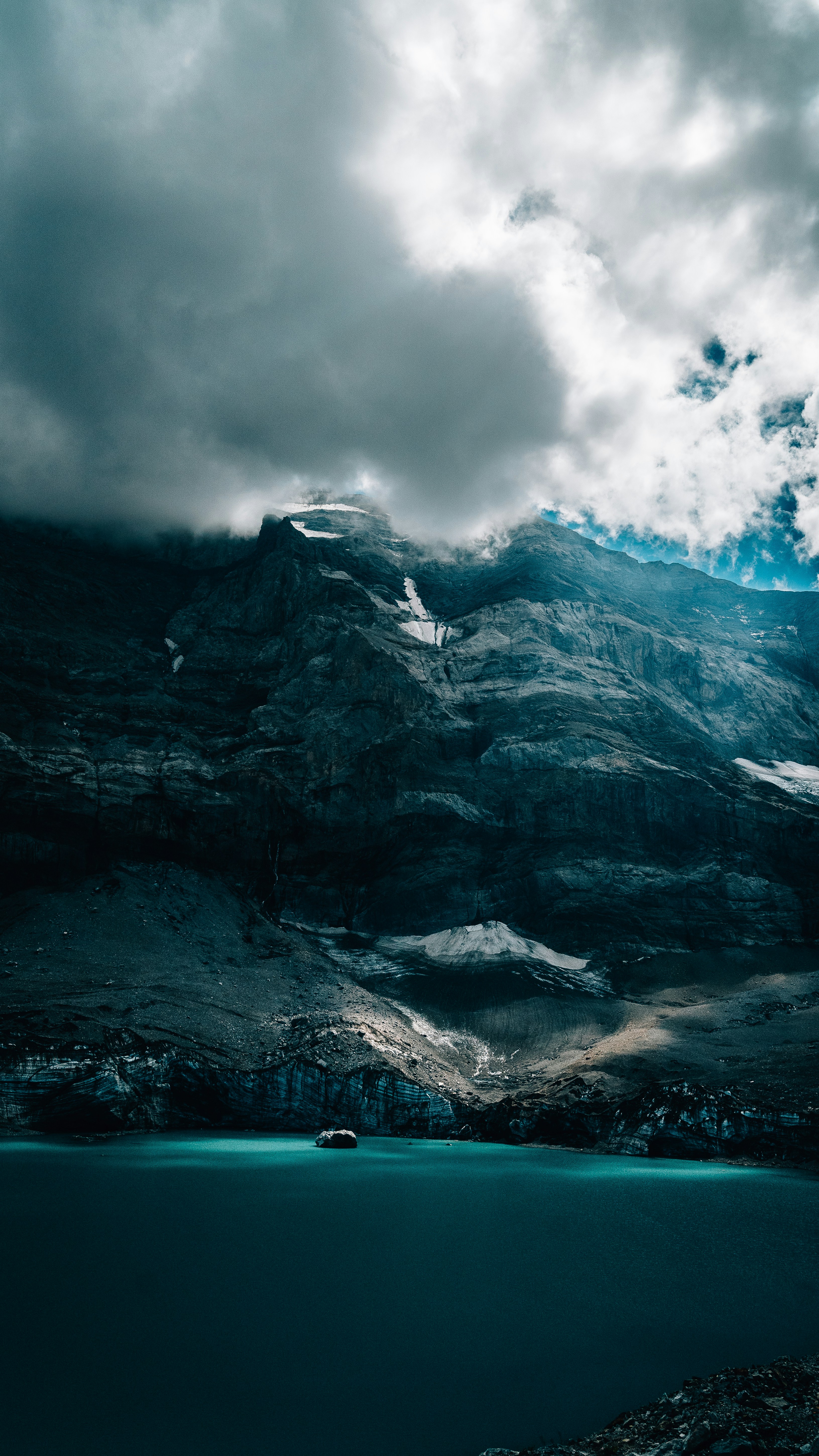 a mountain with a body of water below