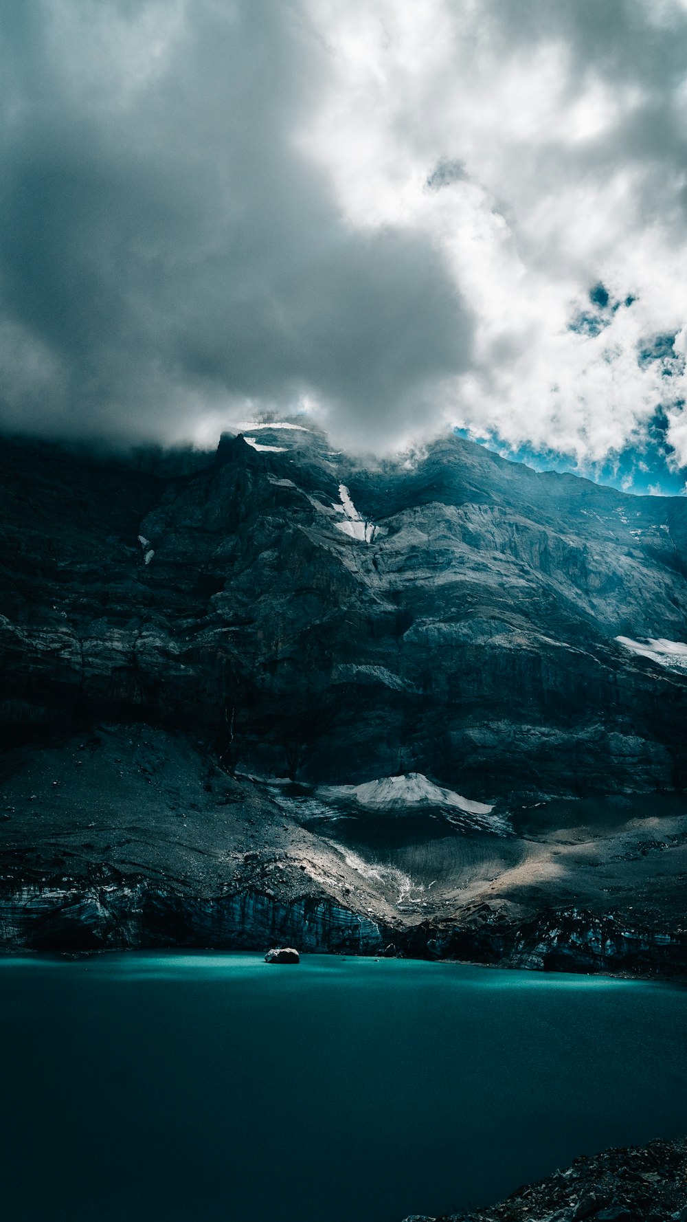 a mountain with a body of water below