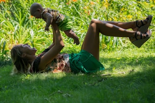 a man and woman lying in the grass