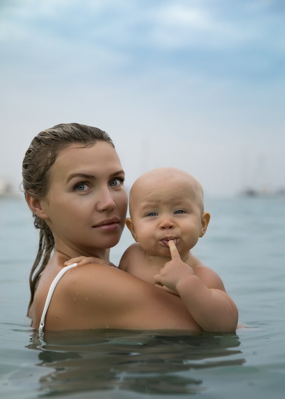a person holding a baby in the water