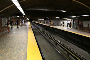 a train station with people waiting