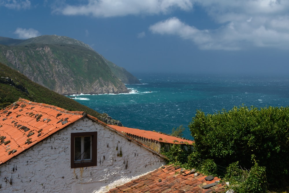 a building with a body of water in the background