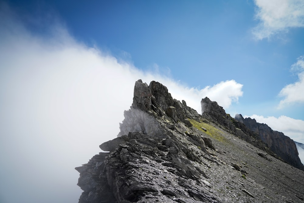 a rocky mountain with clouds