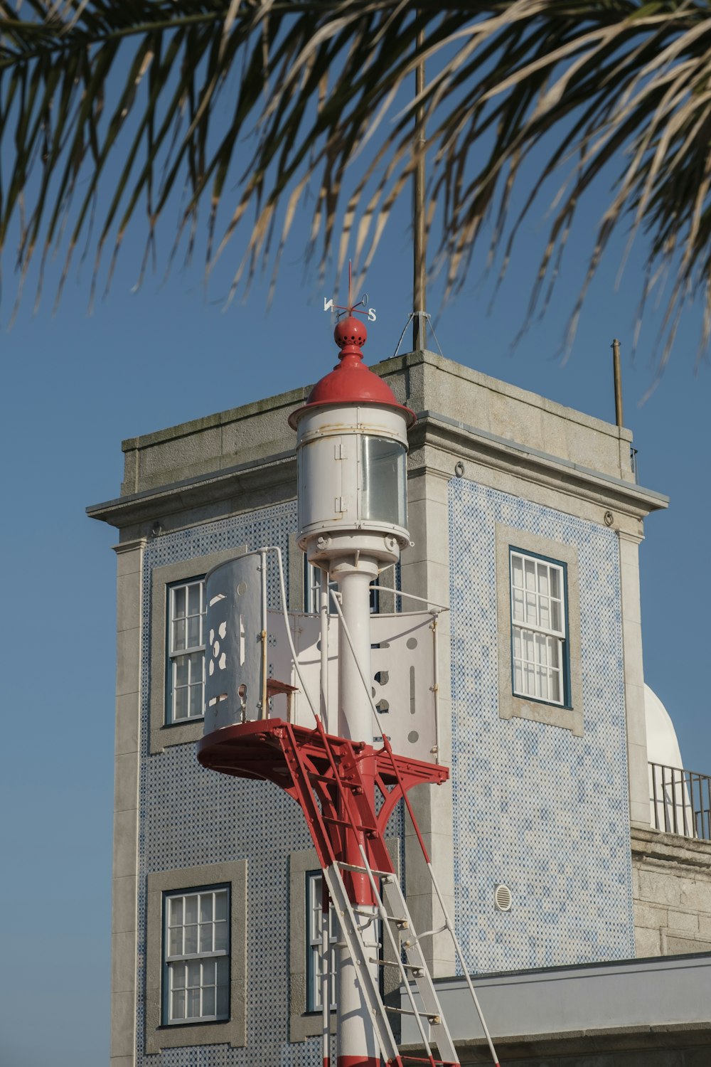 a white tower with a red cross on top