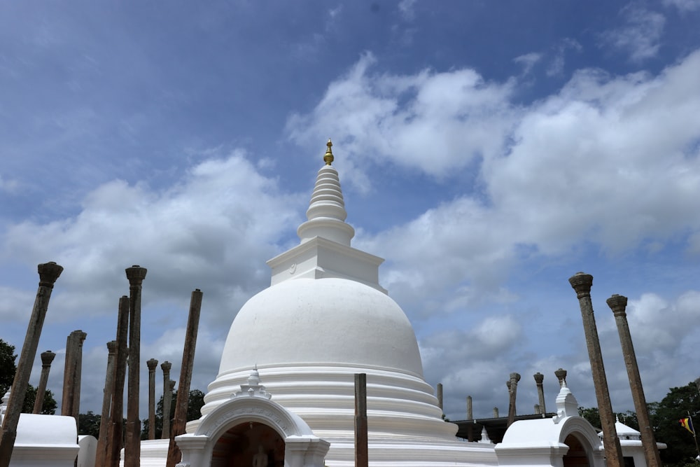 a white building with a gold cross on top