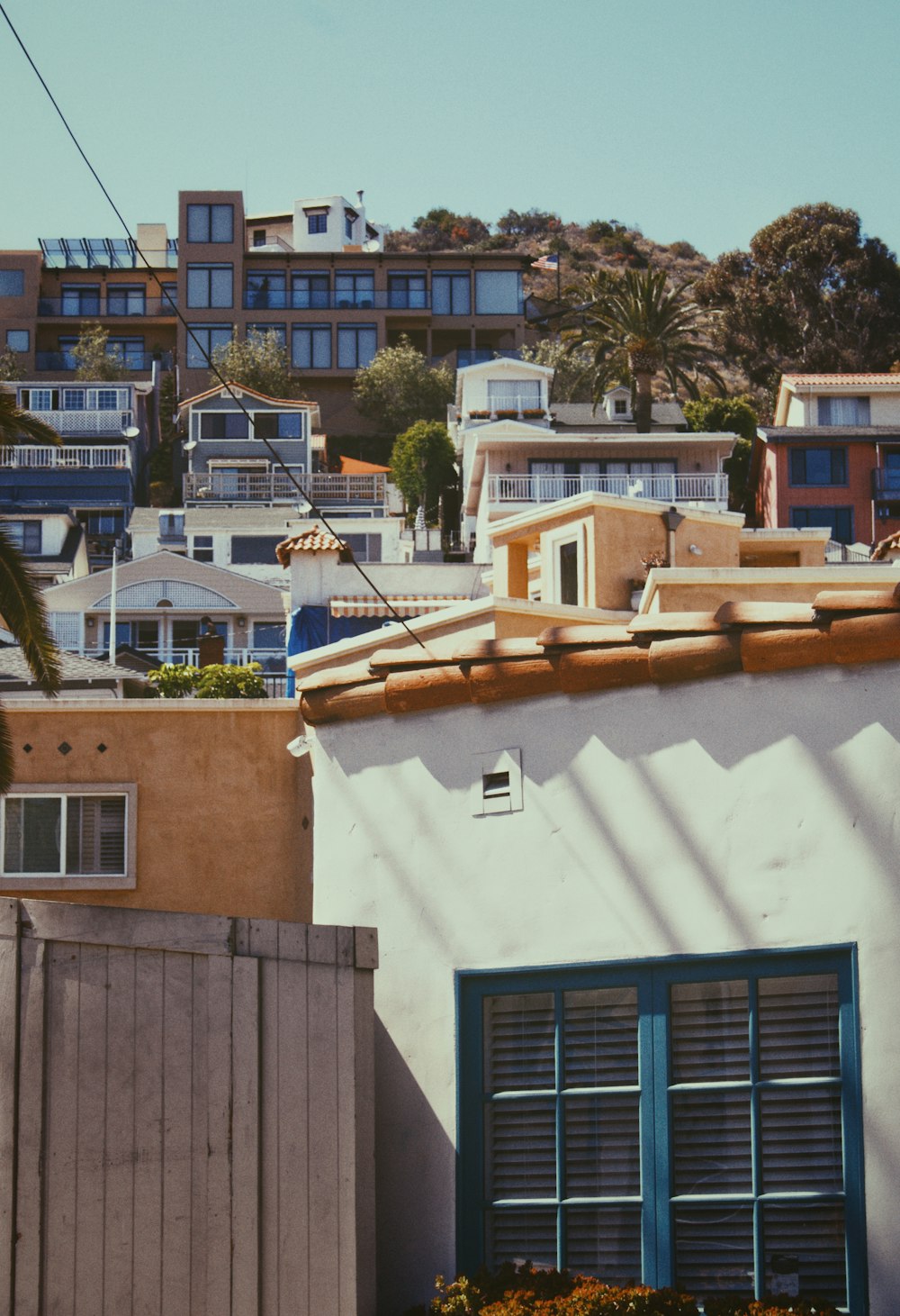 a group of buildings with trees in the background