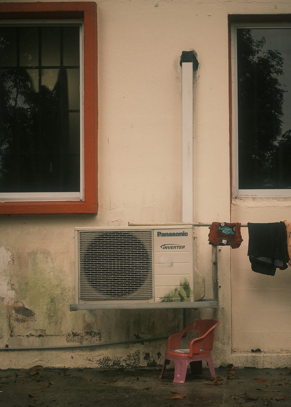 a red chair in front of a white building