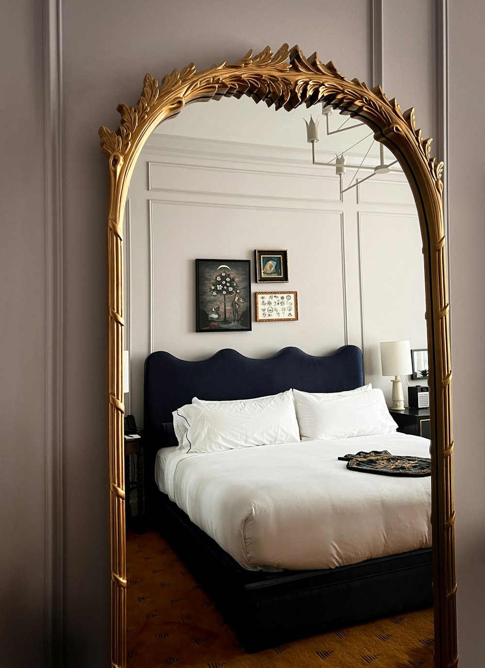 a bed with a mirror over it