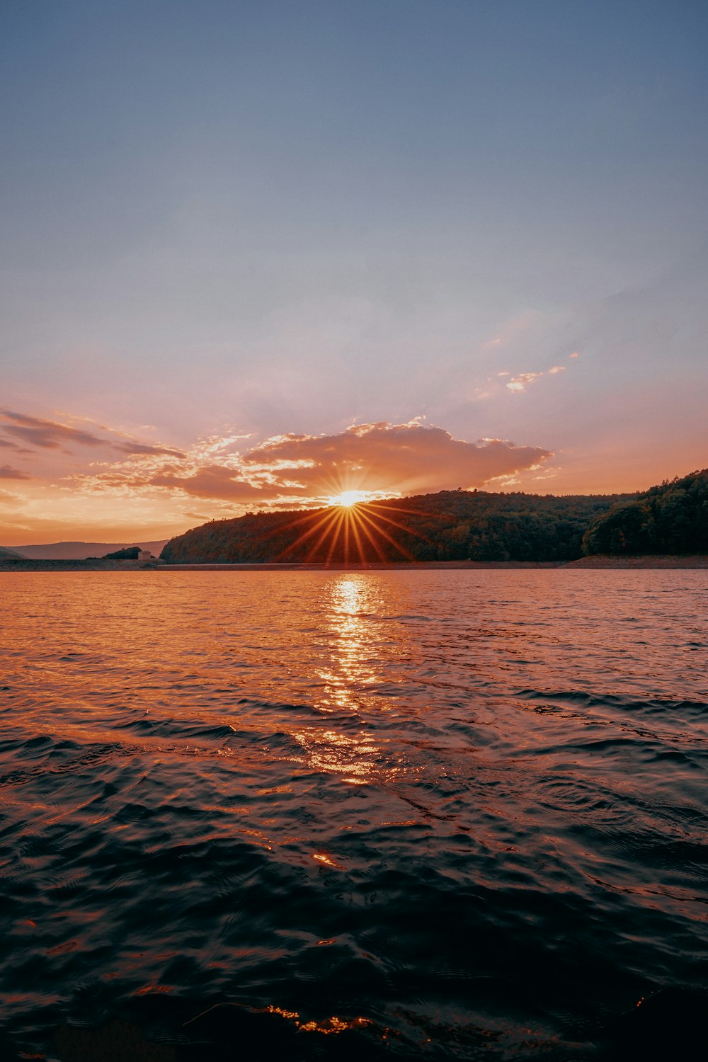 a body of water with a sunset