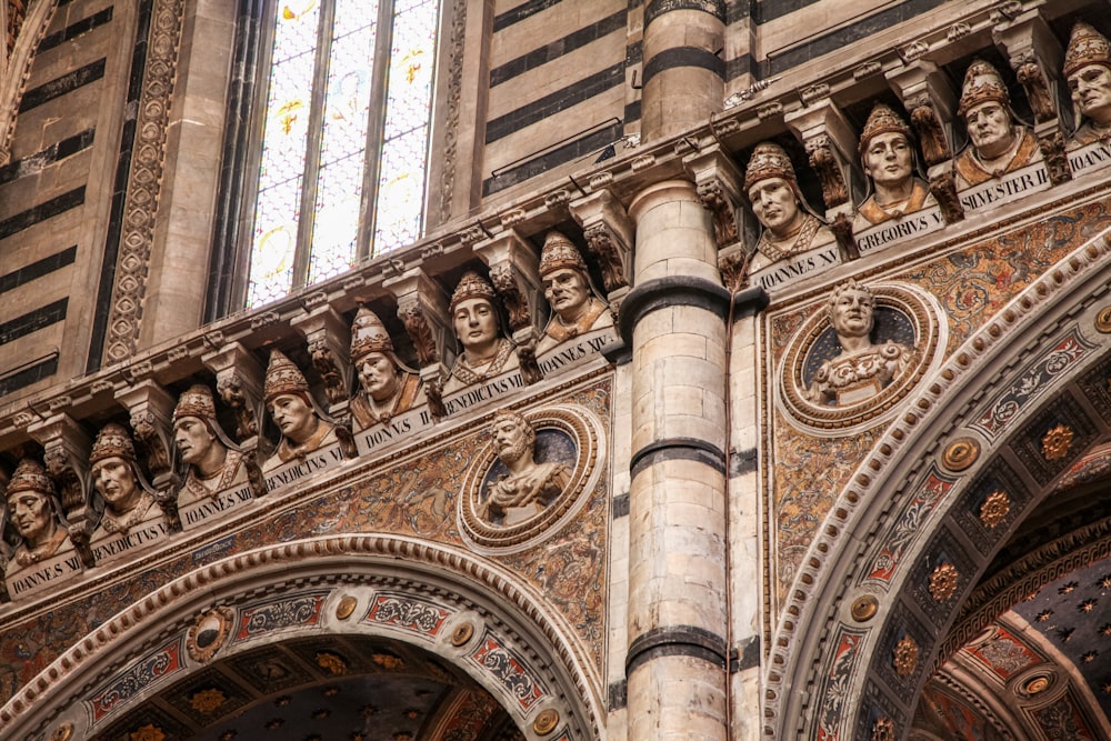 a building with statues on the ceiling