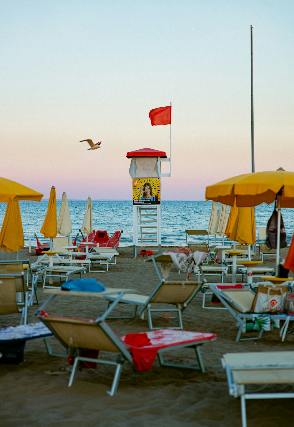 a beach is filled with chairs and umbrellas