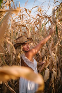a person in a hat in a field of corn