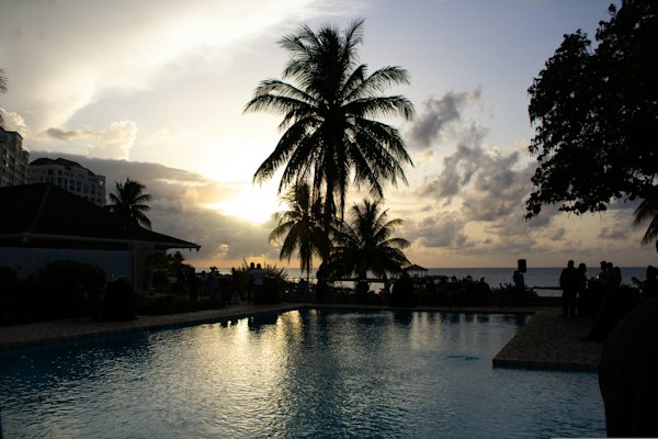 A resort pool at the water's edge at sunset — Montego Bay, Jamaica