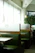 Cozy corner booth in a family diner with sunlight streaming through the window onto a plate of homemade comfort food.