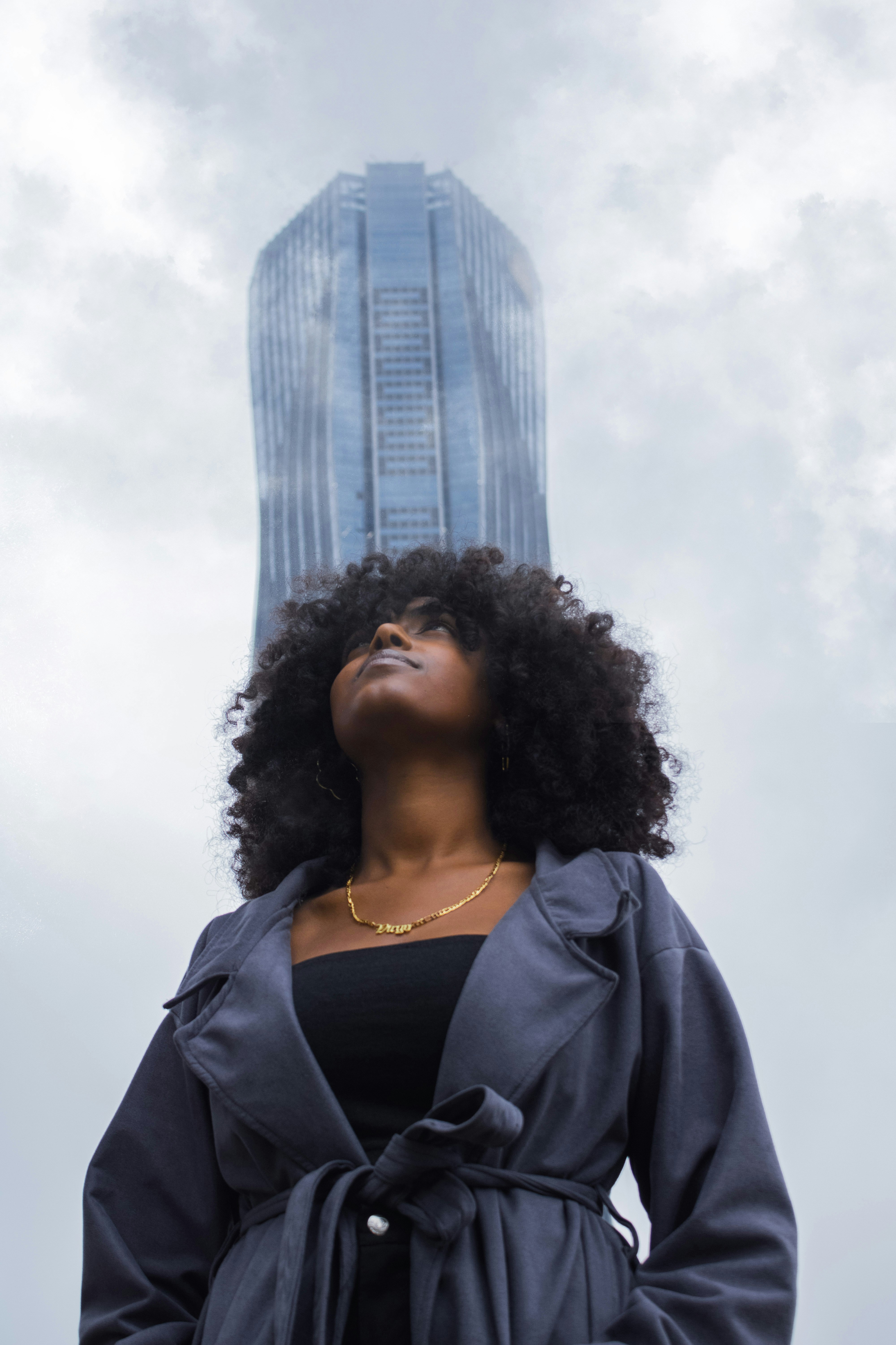 a person with a tall building in the background