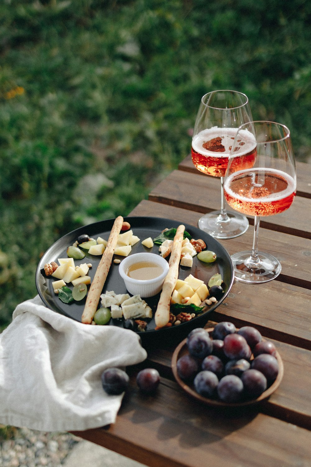 a table with glasses of wine and food on it