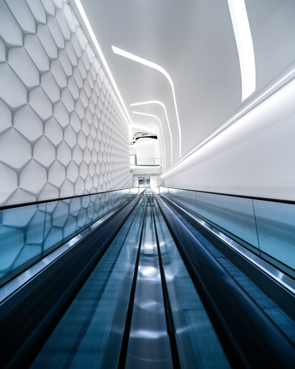 a walkway with white walls