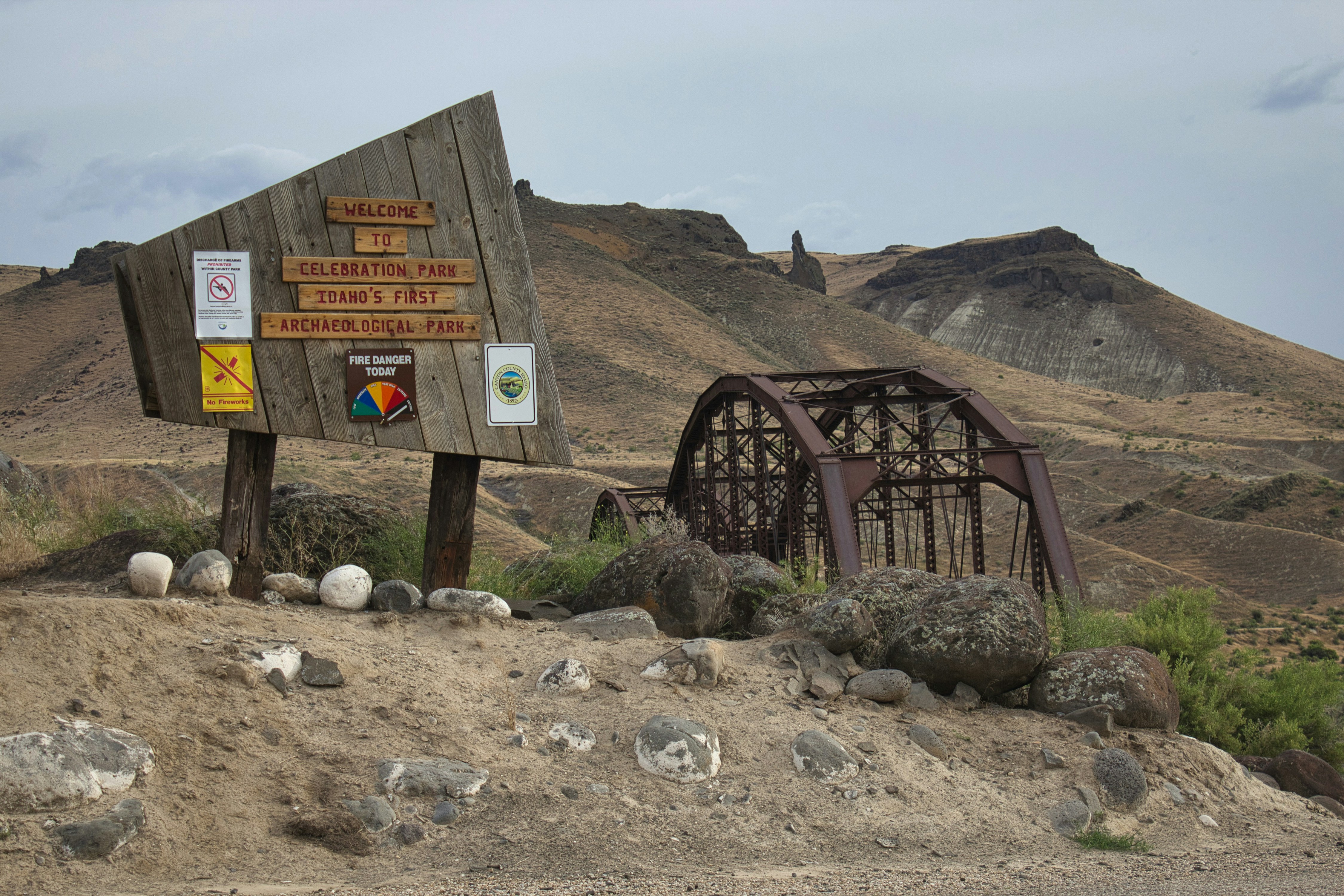 a sign in the middle of a rocky area