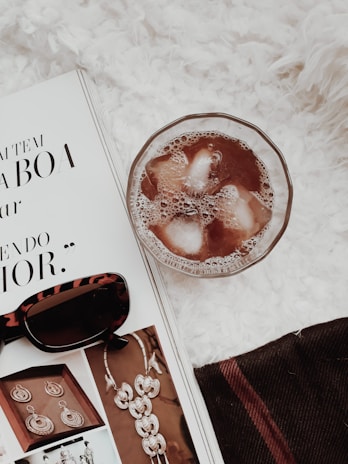 A beautifully styled flat lay of a premium magazine open to a page with heartfelt messages and golden accents.