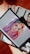 A digital tablet displaying an illustration of a woman with vibrant rainbow-colored hair, featuring shades of purple, green, yellow, and red. The woman's makeup is bold with colorful eyeshadow and red lipstick. The tablet is resting on a stack of magazines, one of which has a black and white cover with a portrait of a person.