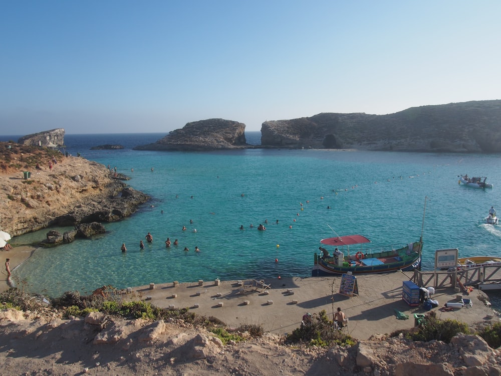 a beach with people swimming in it