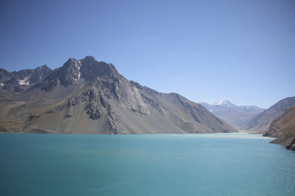 a body of water with mountains in the background