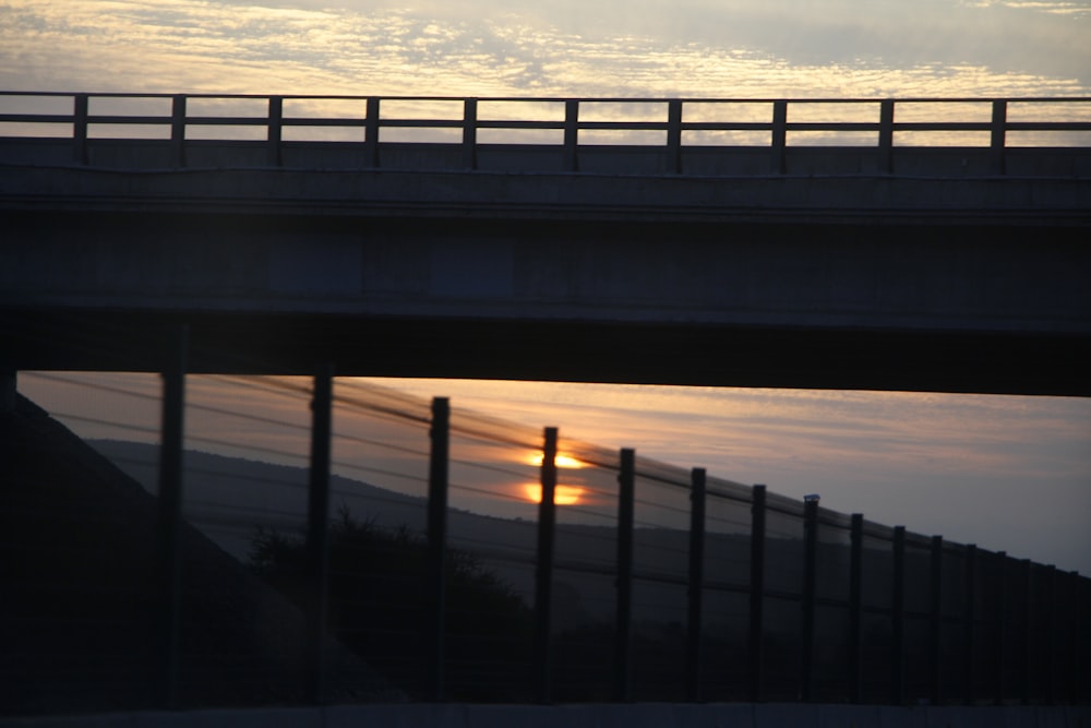 a bridge with a sunset