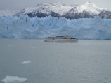 A boat navigating the icy waters of the Beagle Channel with glaciers in the background.