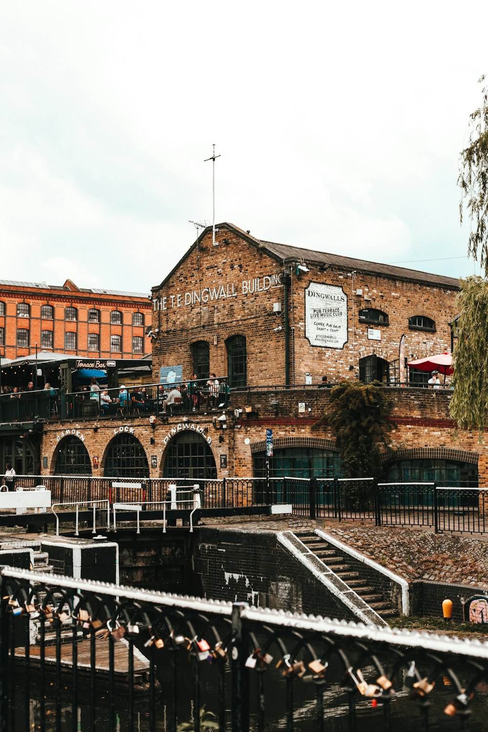 a brick building with a black fence