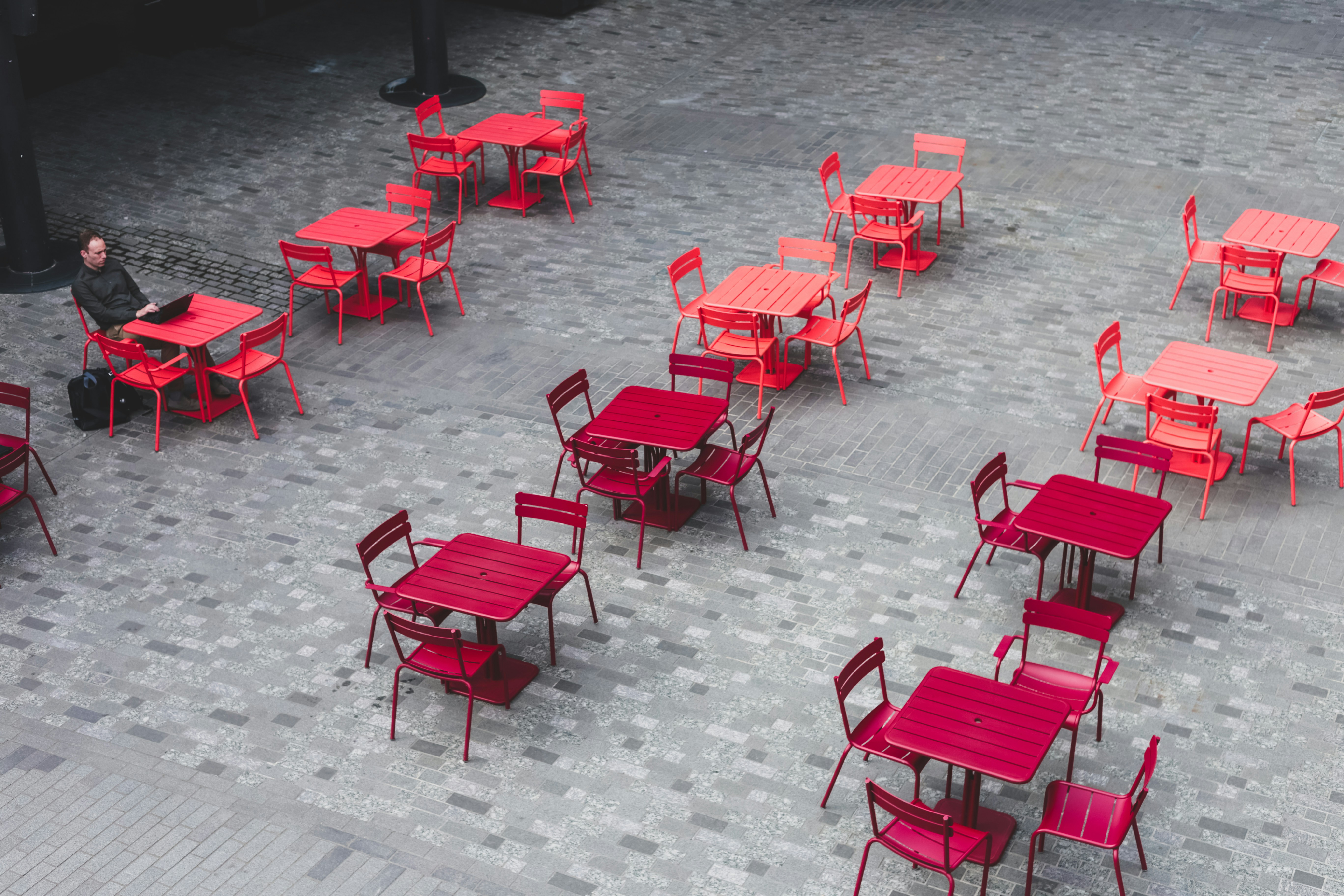 a group of red tables and chairs
