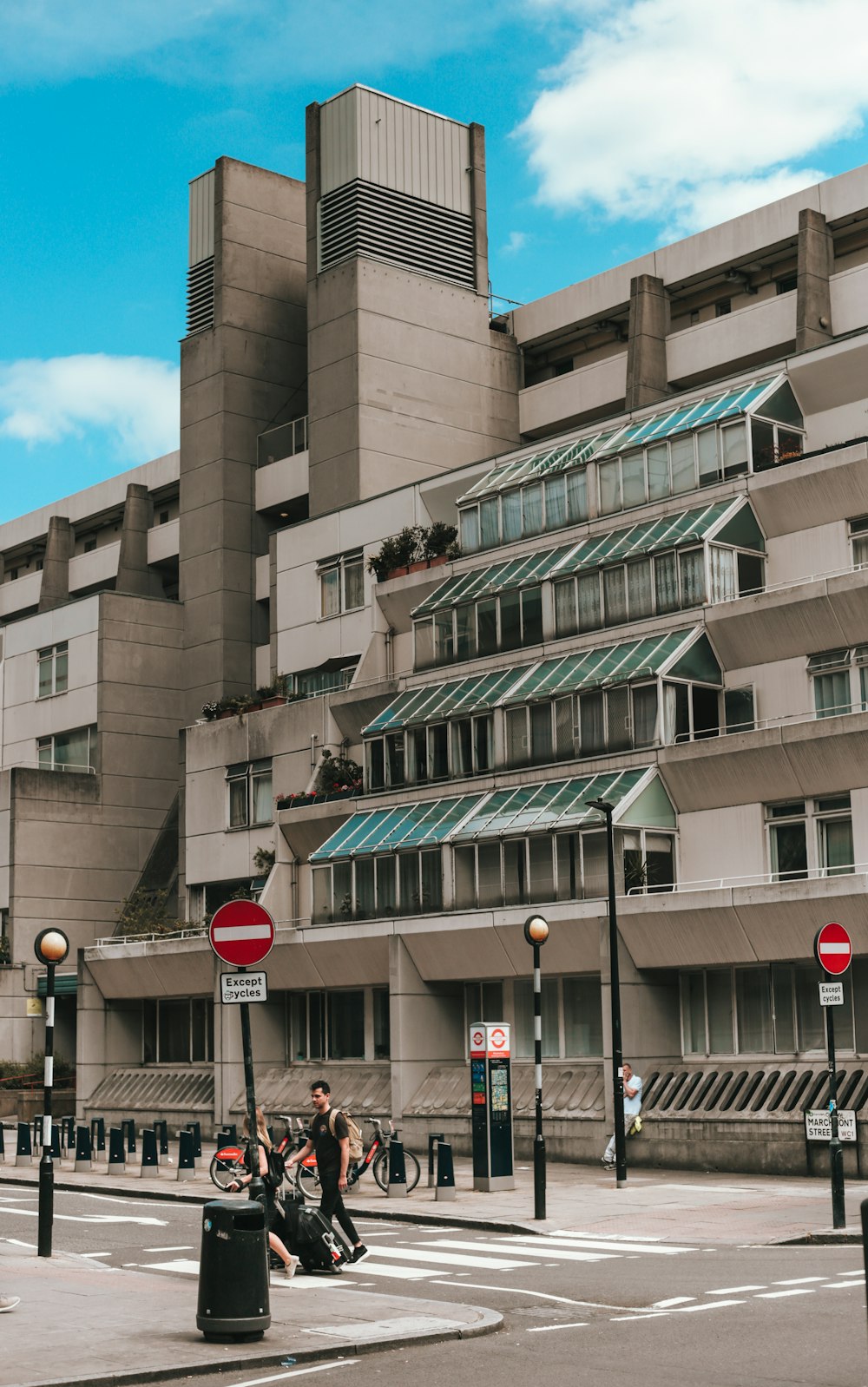 a large building with a person riding a bicycle