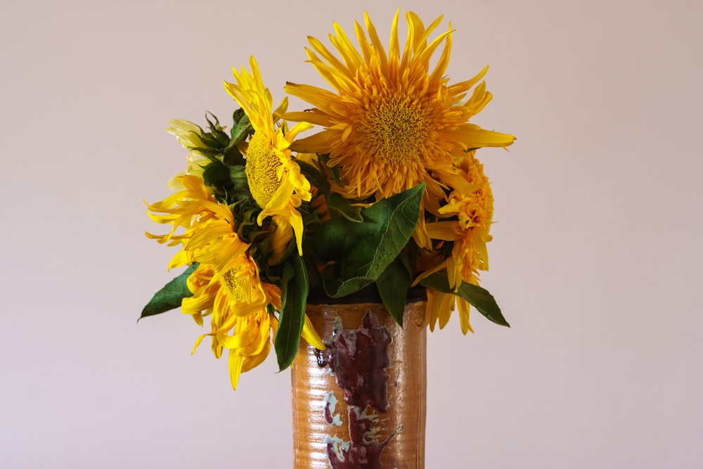 a vase with yellow flowers