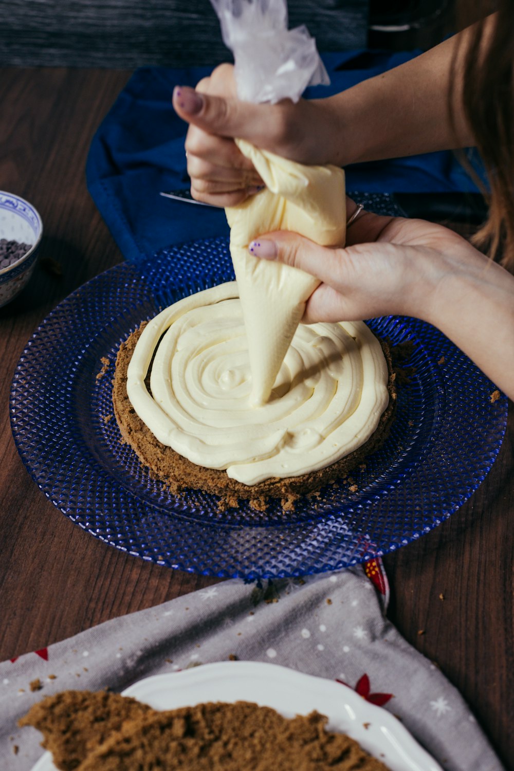 a person holding a banana over a cake