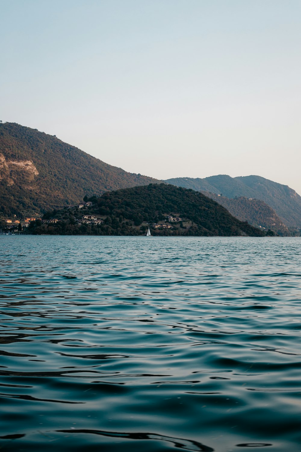 a body of water with mountains in the background