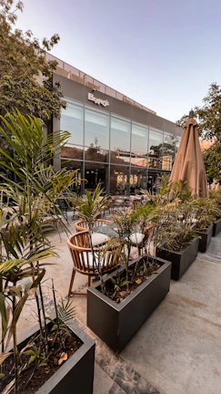 Outdoor seating area with fiber glass planters and comfortable cushions.