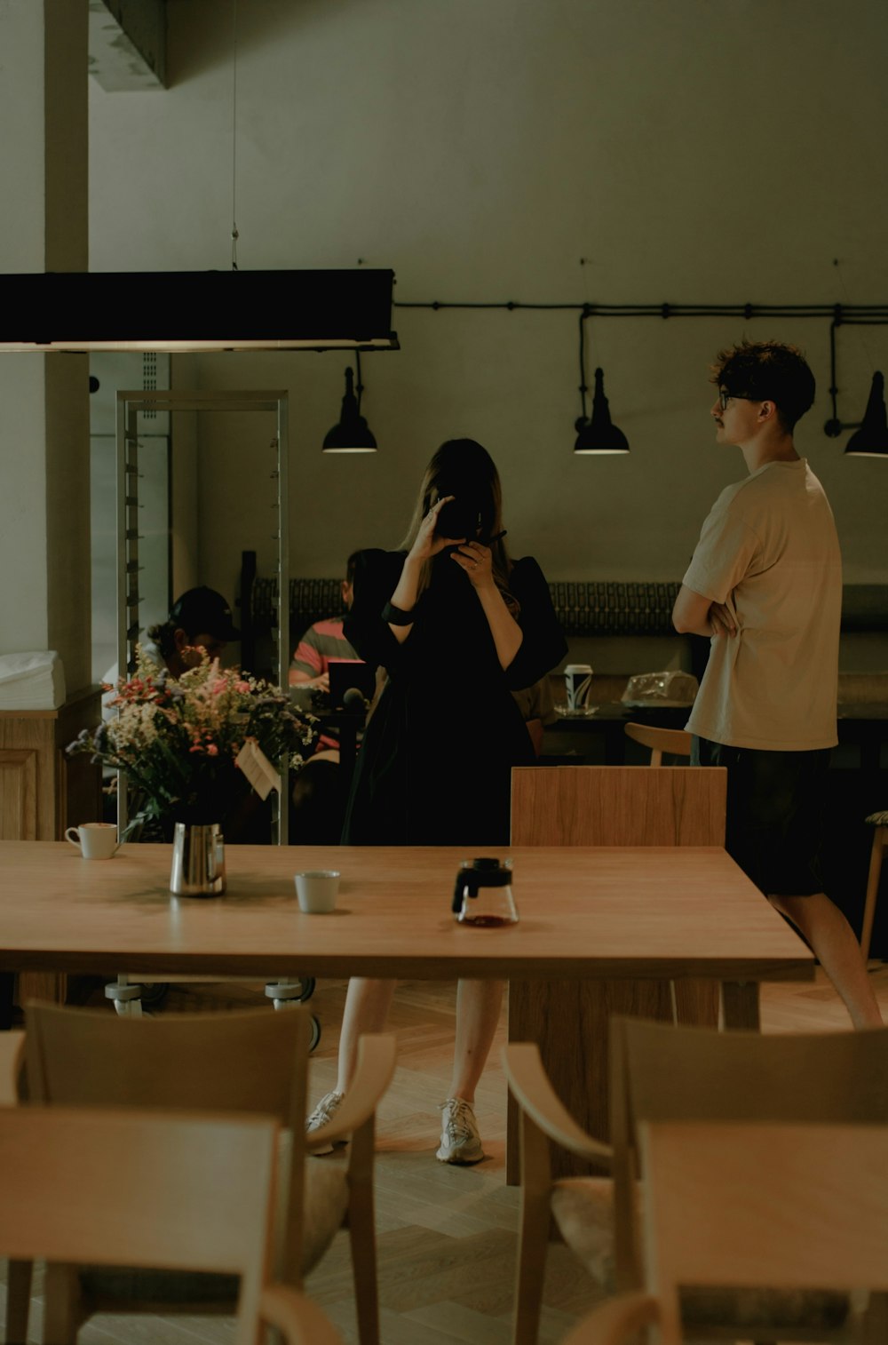 a man and woman standing in a kitchen