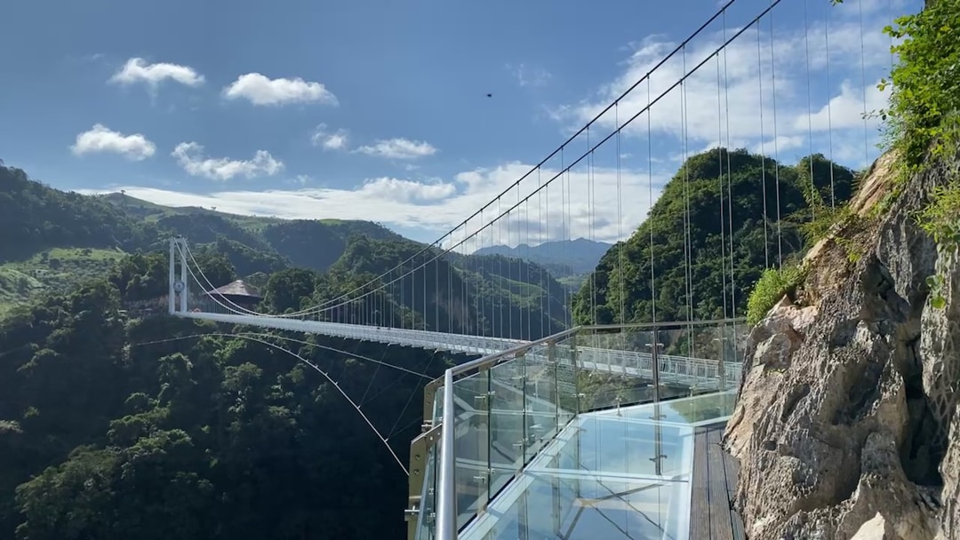 Glass bridge walkway spanning canyon scenery