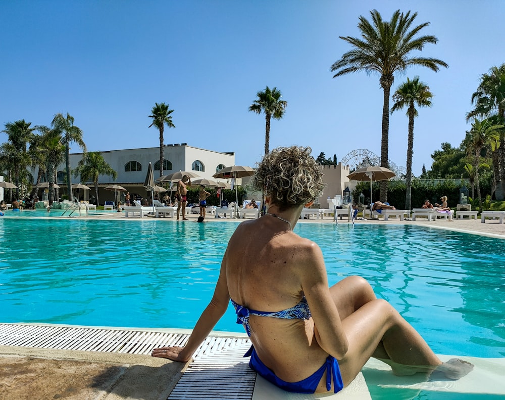 a person sitting on a pool